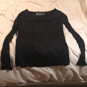 Long sleeved black knit top with flirty neck